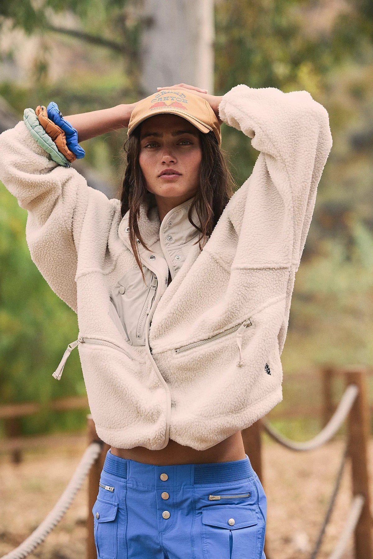 Women’s sherpa jacket in cream with snap front and stand collar; zip pockets