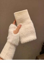 White fuzzy fingerless gloves with ribbed wrists and plush hand sections