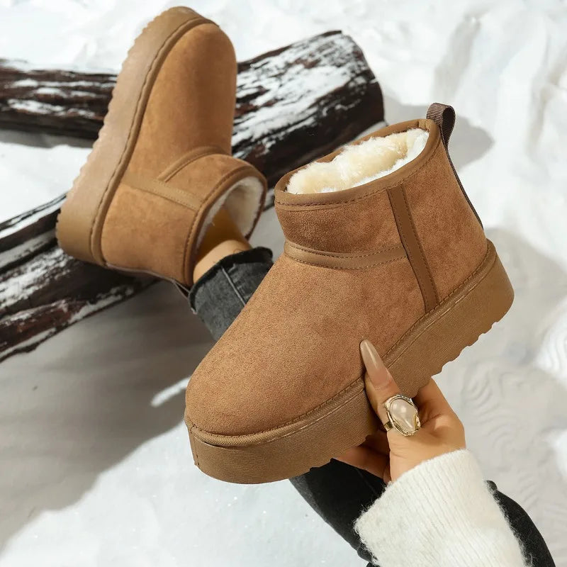 Khaki faux suede pull-on boots with fur lining and thick tread soles, shown in hand