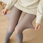 Gray sheer thermal tights stretched by hand to show their elasticity