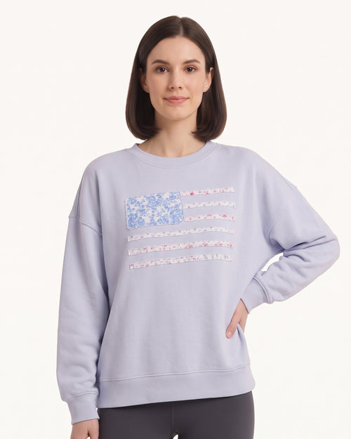 Light blue crewneck sweatshirt with floral American flag stripes graphic, long sleeves