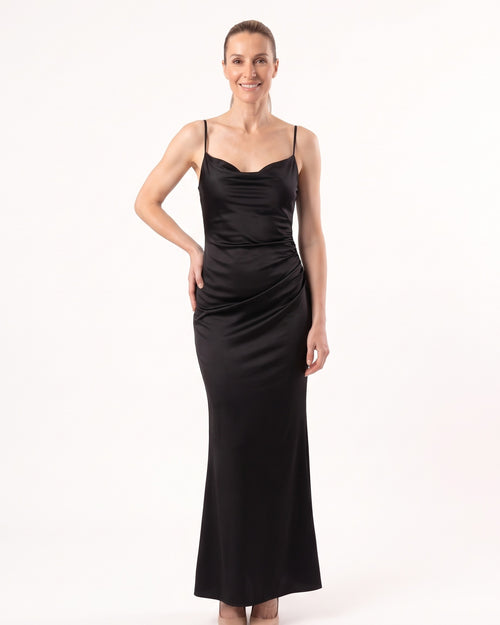 Black satin maxi slip dress with thin straps and cowl neckline, sleek fitted drape.