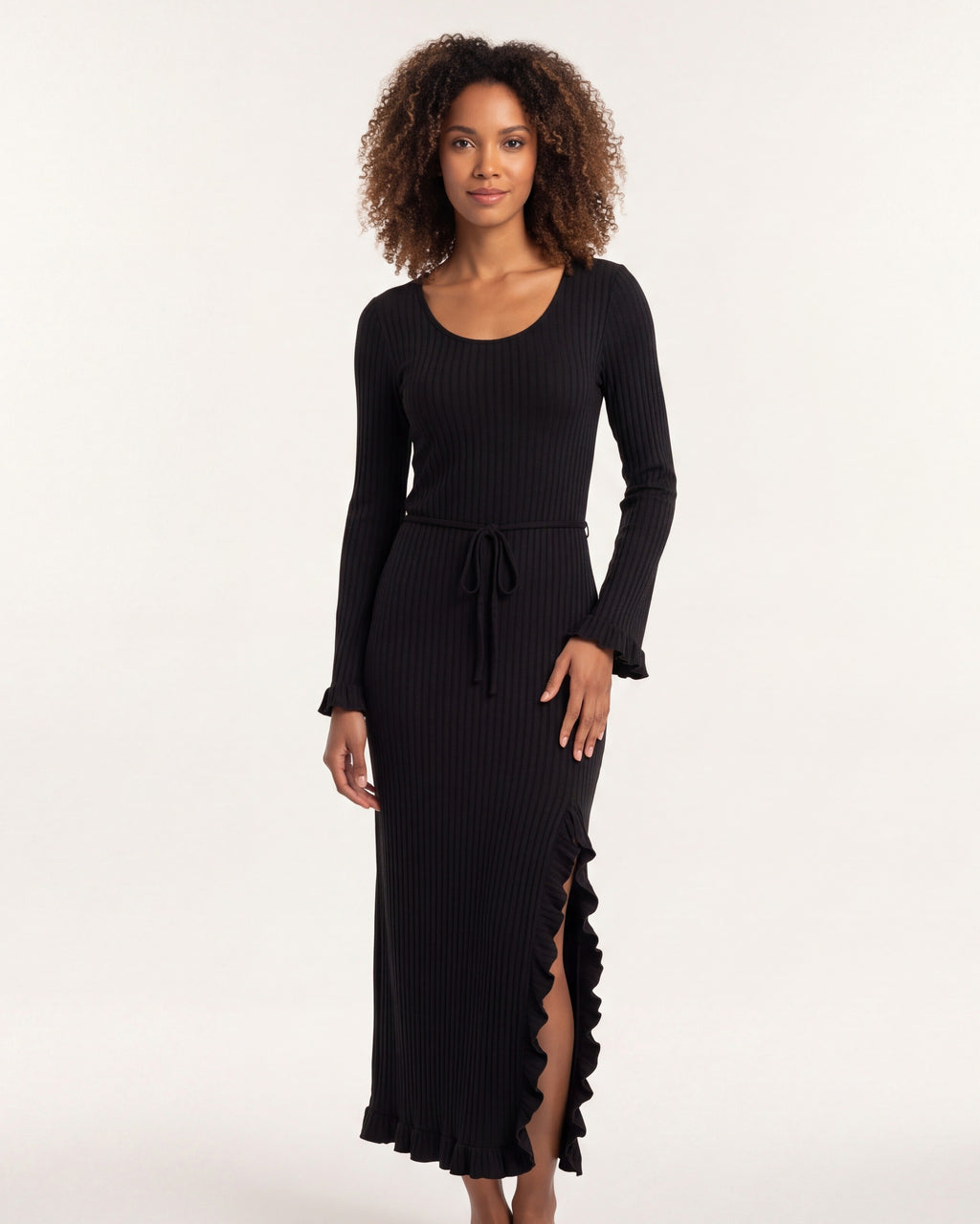 Black ribbed knit maxi dress with scoop neck, tie waist, bell sleeves, lettuce hem.