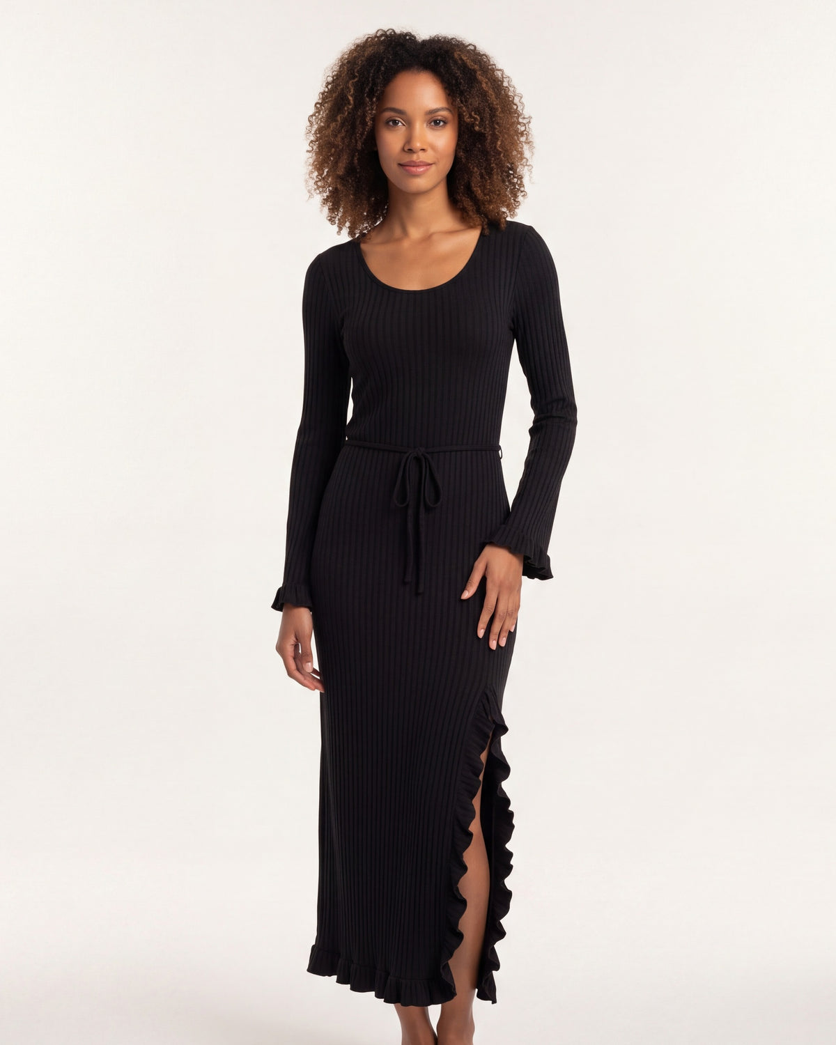 Black ribbed knit maxi dress with scoop neck, tie waist, bell sleeves, lettuce hem.