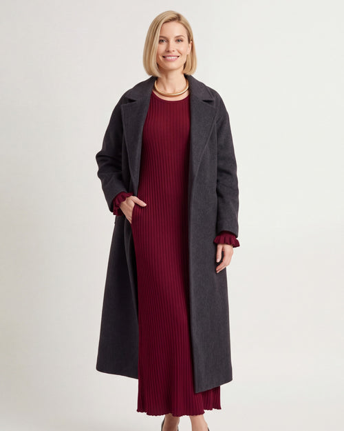 Burgundy ribbed knit maxi dress with V-scoop neckline, tie waist, bell sleeves.