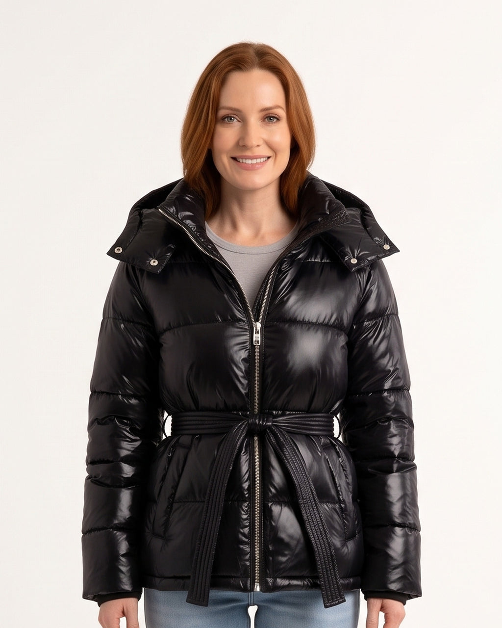 Black glossy hooded belted puffer jacket with tie waist, stand-collar zip front