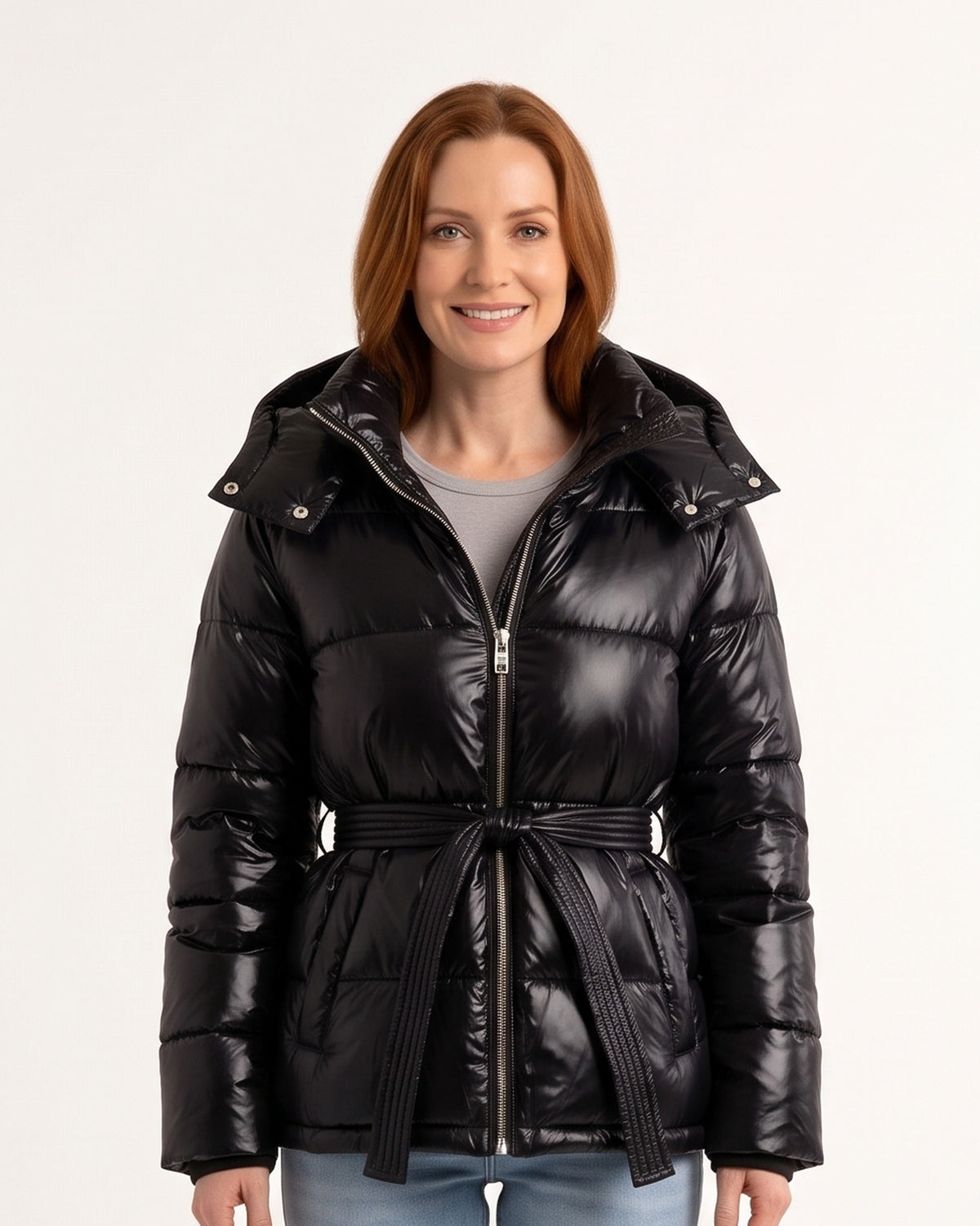 Black glossy hooded belted puffer jacket with tie waist, stand-collar zip front