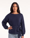 Navy knit pullover with a tie waist, boat neckline, and balloon sleeves