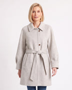 Women's off-white wool coat with raglan sleeves, single-breasted buttons, and a tied belt