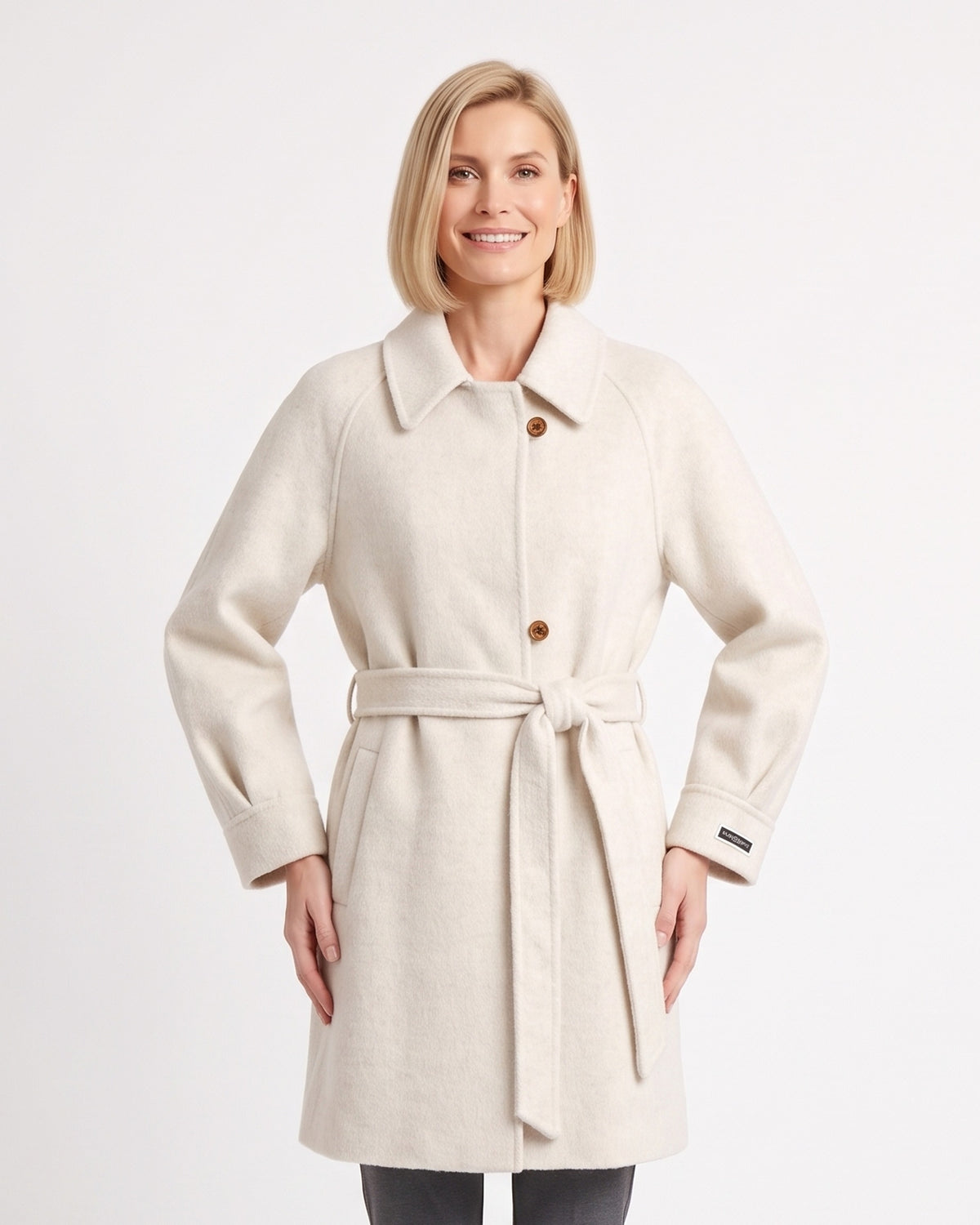 Off-white wool coat with a notched collar, button front, raglan sleeves and tied belt