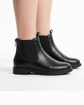 Women’s black Chelsea boots with elastic sides and low block heel, standing view