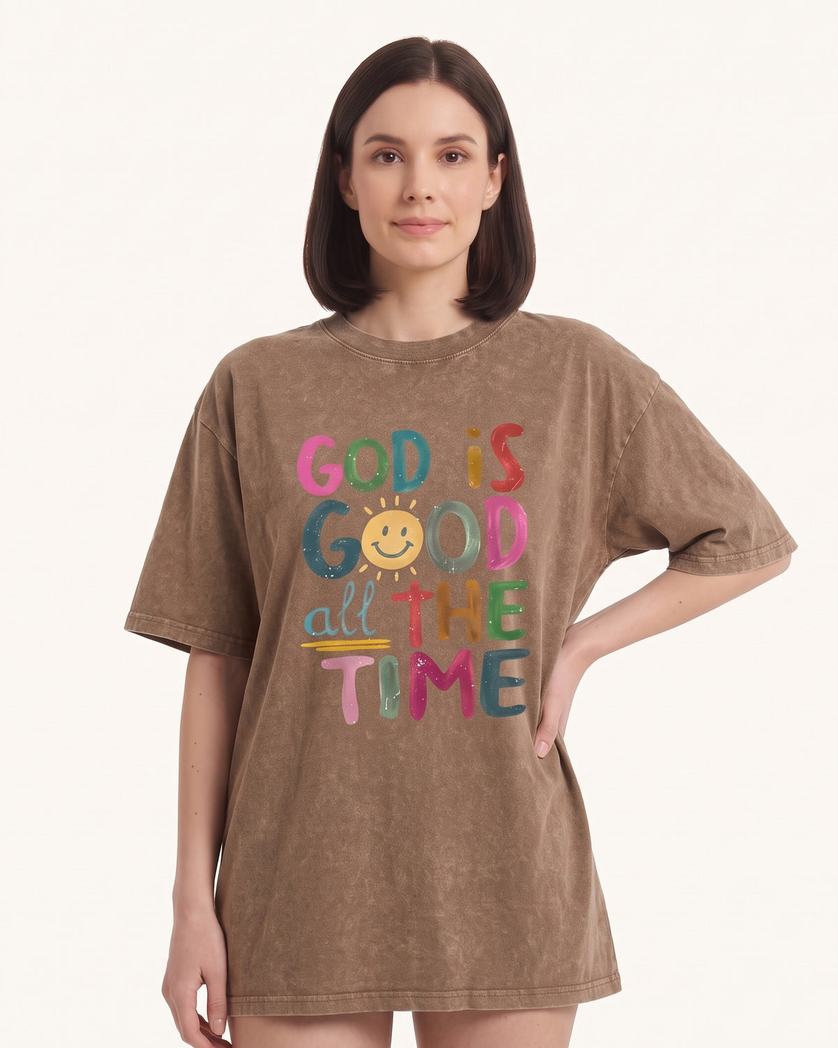 Women's oversized graphic T-shirt in brown with colorful 'God is Good' typography