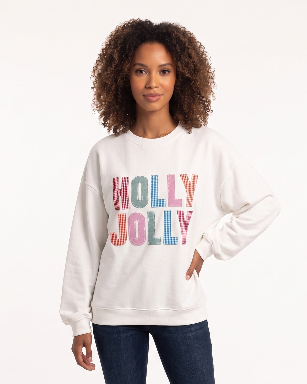White crewneck sweatshirt with “Holly Jolly” multicolor check patch logo