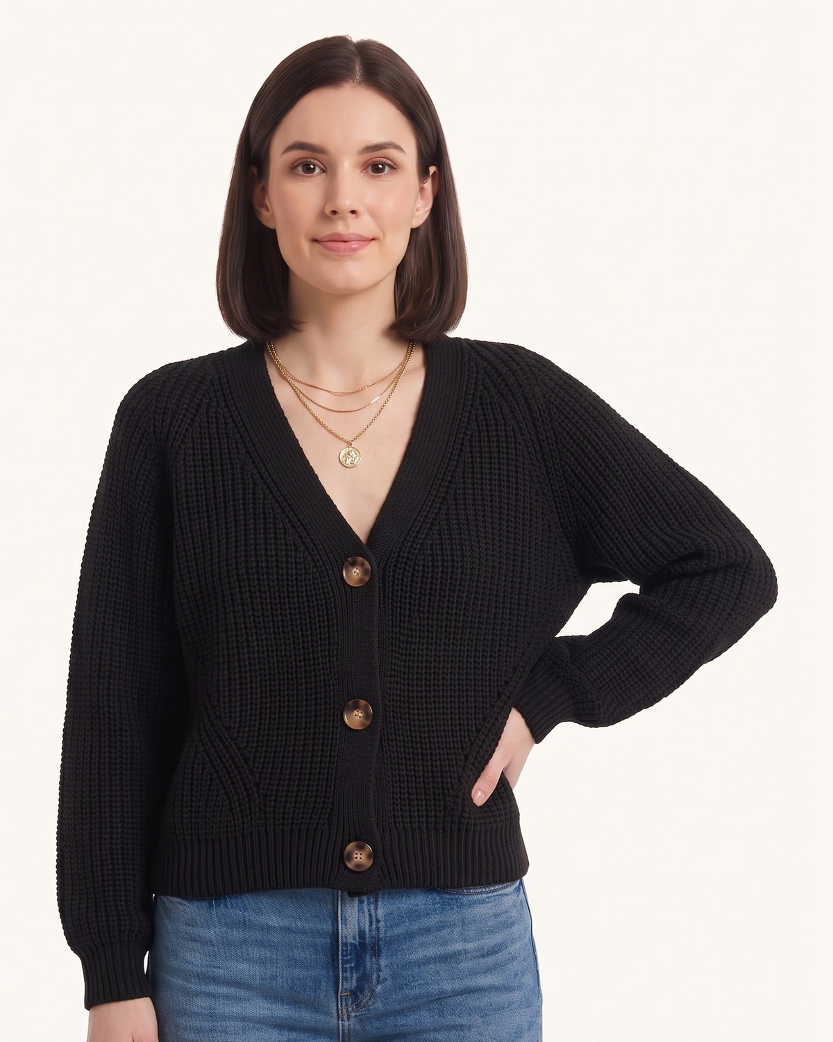 Chunky knit cardigan in black with V-neck, button front, and balloon sleeves