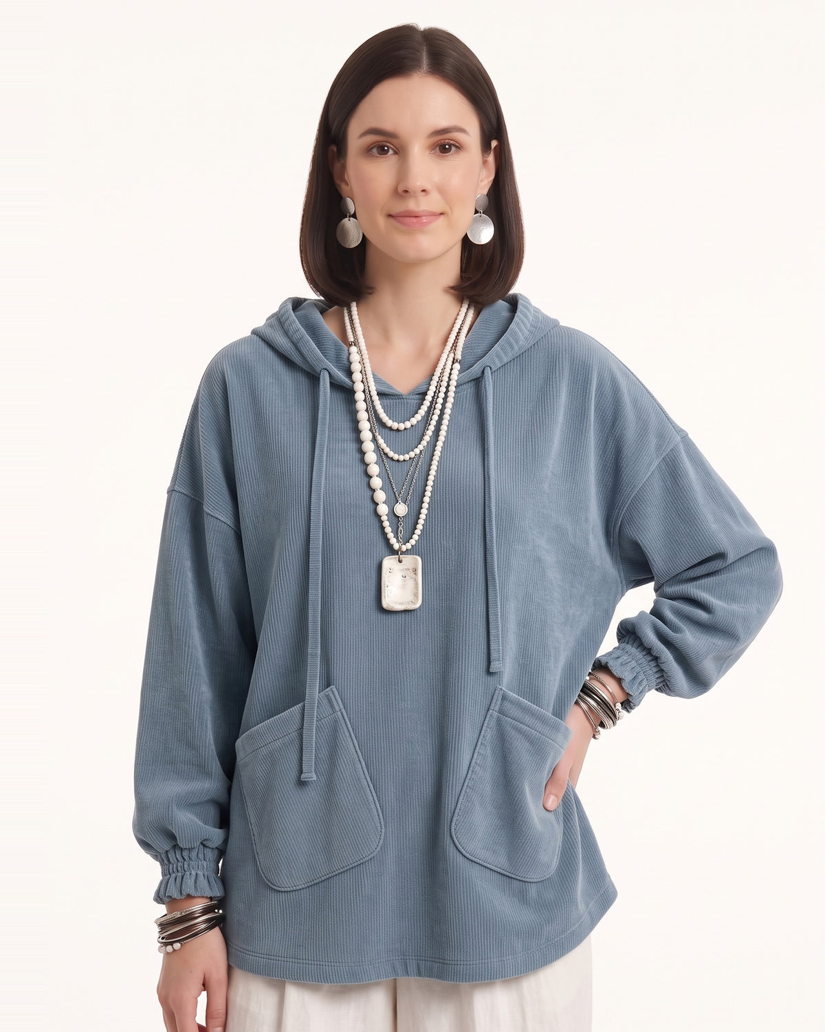 Light blue corduroy oversized pullover hoodie with drawstring hood and patch pockets.