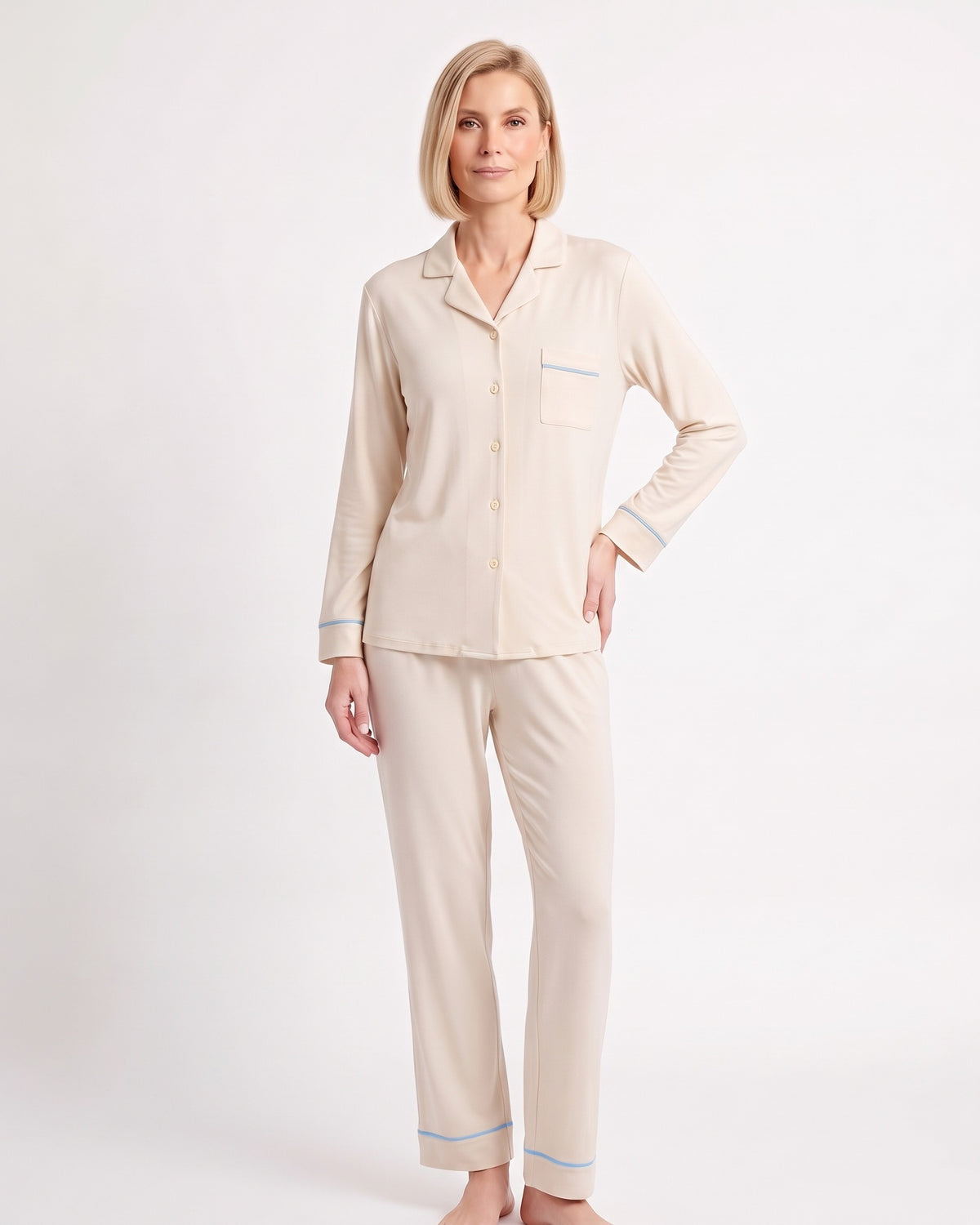 Women's cream cotton pajama set with button-up top, chest pocket, and blue piping