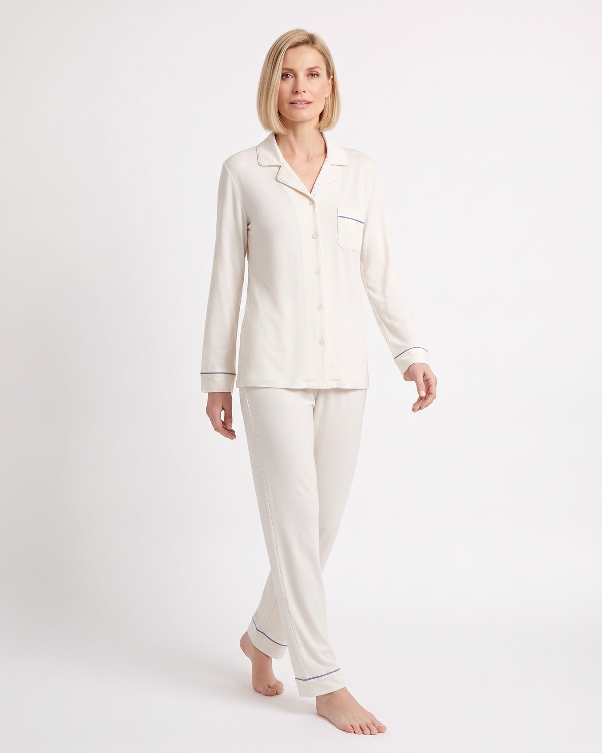 Women's cream pajama set with long sleeves, button front, straight-leg pants, and blue piping