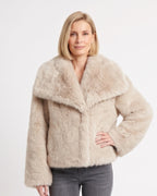 Beige cropped faux fur jacket with oversized lapel collar and long sleeves