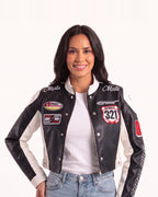 Cropped black-and-white moto jacket with stand collar, snap front, and racing patch embroidery