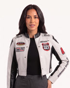 Cropped black-and-white moto jacket with stand collar, snap front, and embroidered racing patches