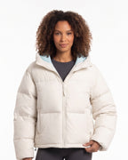 Cropped hooded puffer jacket in off-white with full front zipper and quilted insulation.