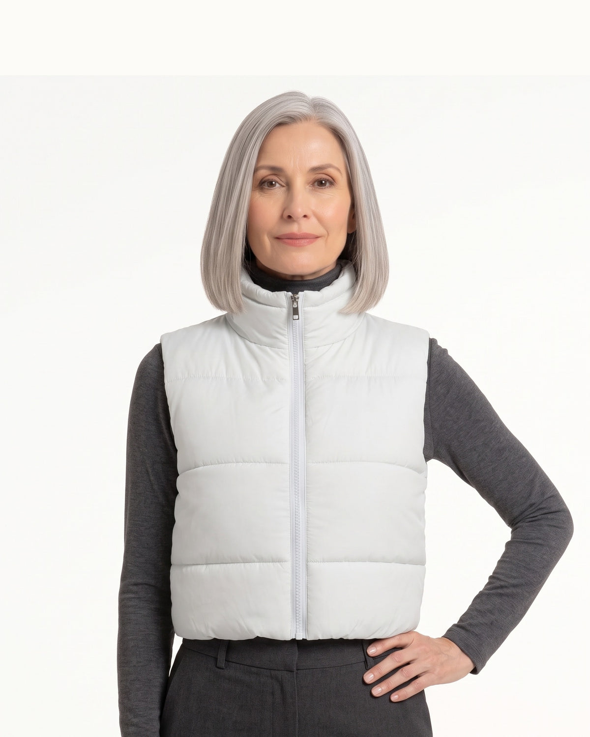 White cropped puffer vest with stand collar, front zip, and quilted padding