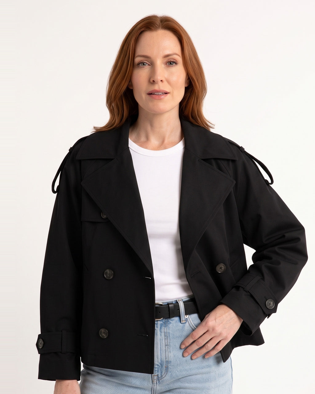 Black cropped trench coat with double-breasted buttons and belted waist, adjustable cuff tabs