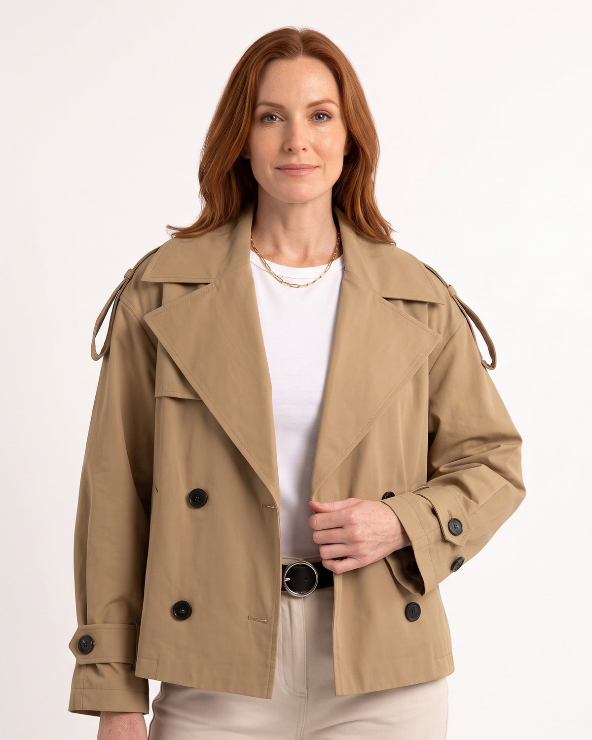 Beige cropped trench coat with double-breasted buttons, belted waist, cuff tabs
