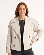 Cream cropped trench coat with double-breasted buttons and belted waist, cuff tabs