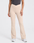 Beige high-waisted crossover flare yoga leggings with V-shaped seam detail.