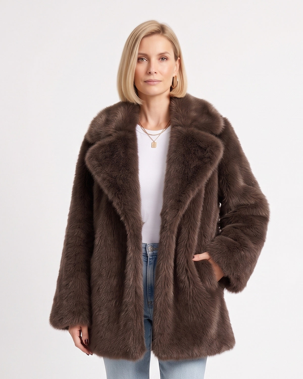 Brown fluffy faux fur coat with wide lapels and a hand tucked into a side pocket