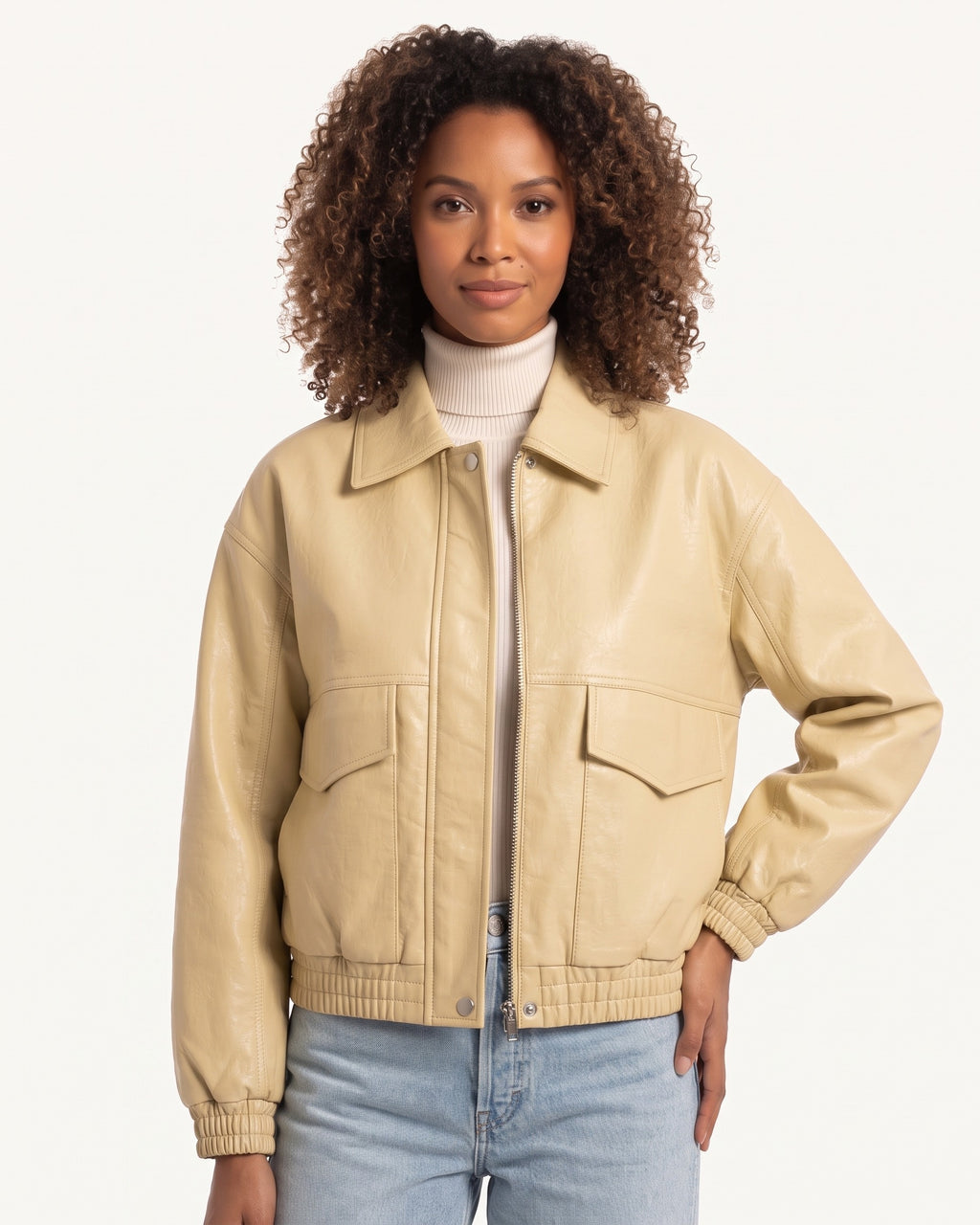 Beige faux leather cropped bomber jacket with zip front and flap pockets at chest