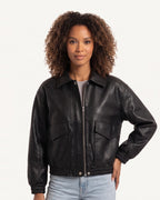 Black faux leather cropped bomber jacket with zip front and flap chest pockets