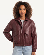 Burgundy faux leather cropped bomber jacket with zip front, stand collar, and flap pockets