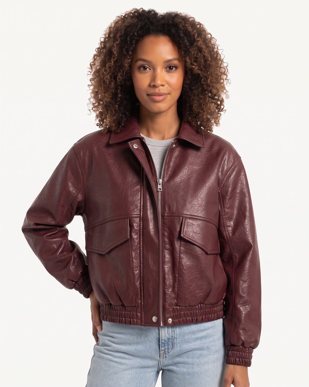 Burgundy faux leather cropped bomber jacket with zip front, stand collar, and flap pockets