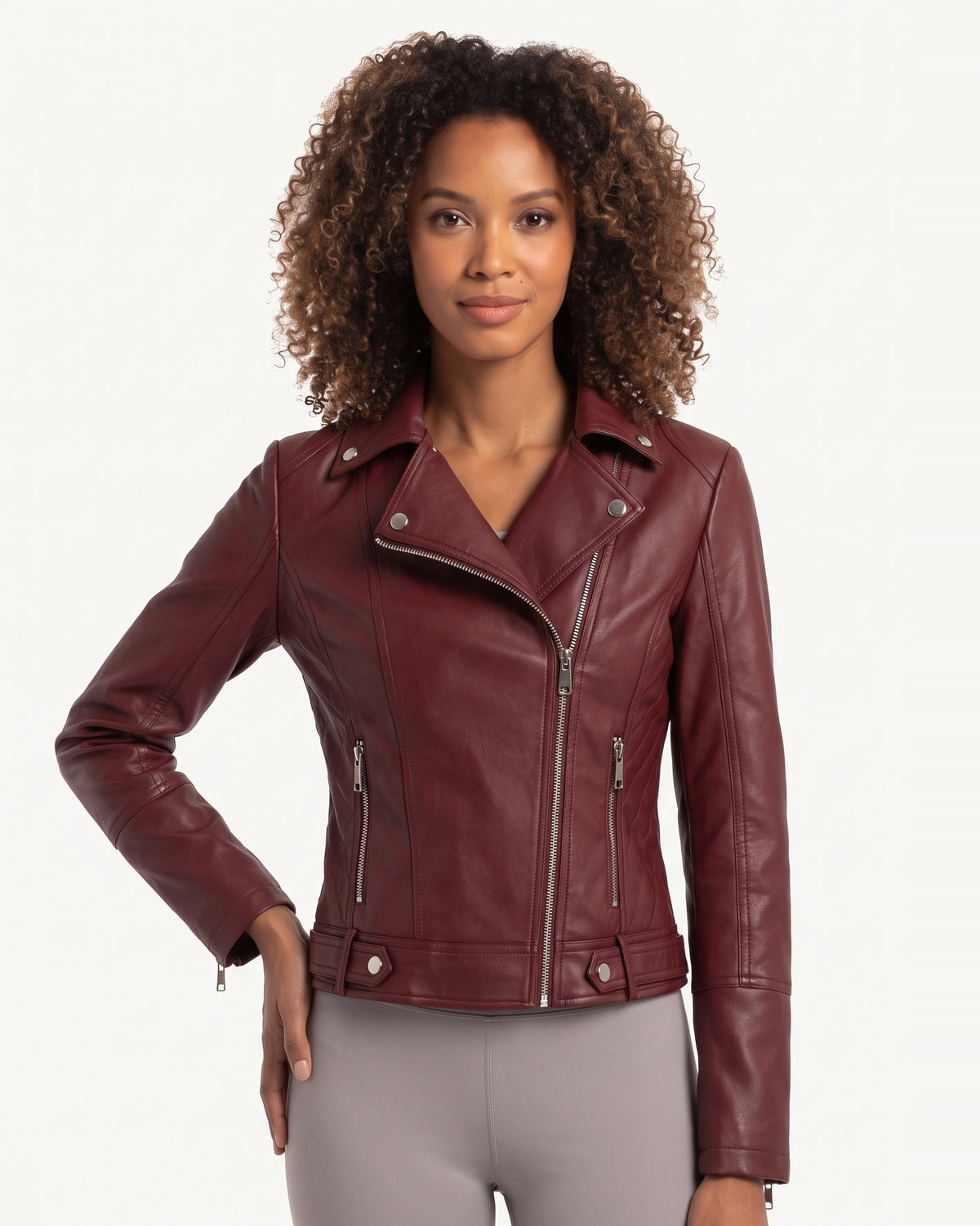 Burgundy moto jacket on model, asymmetrical zip front, snap collar, side zip accents.
