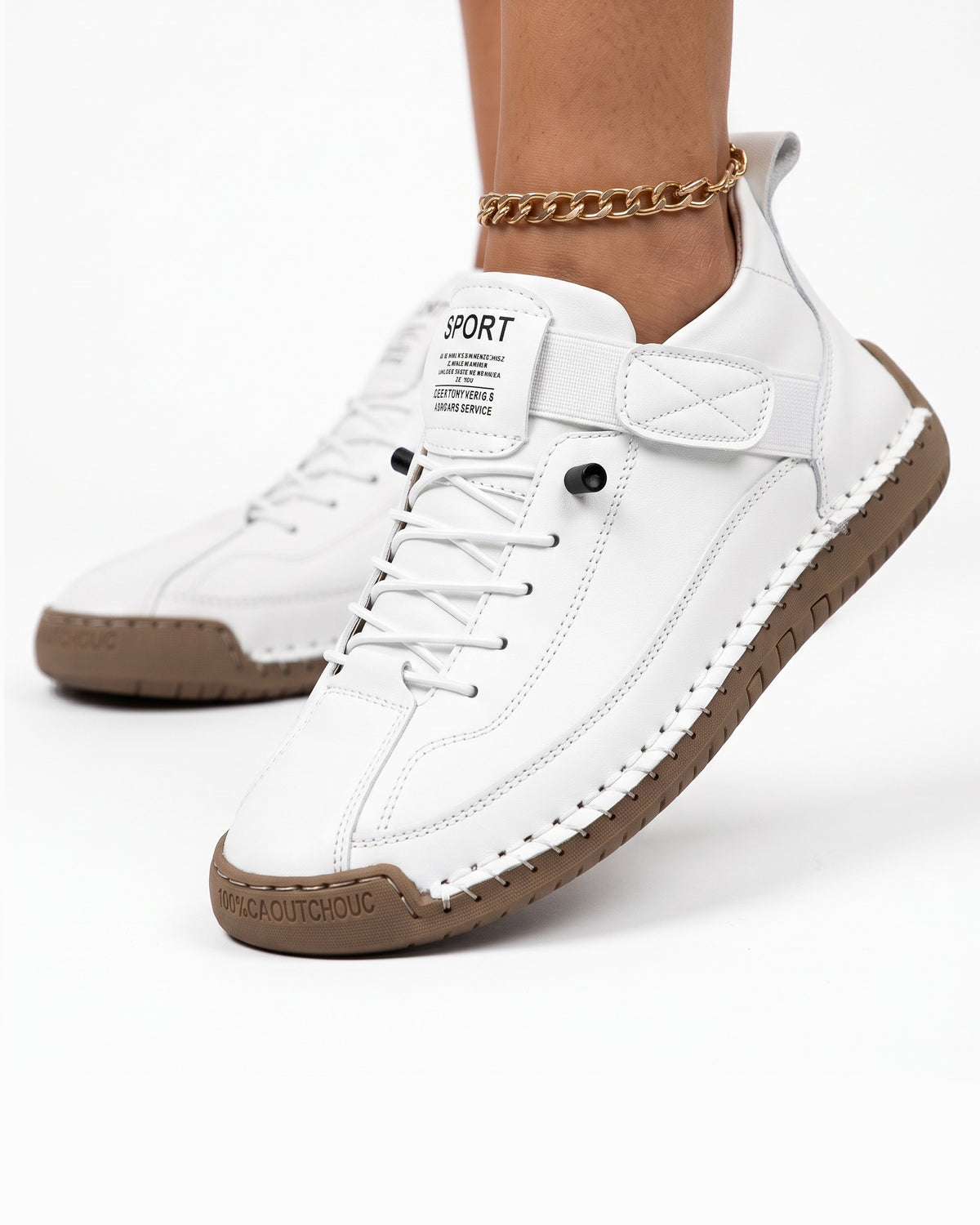 White faux leather lace-up sneaker with ankle strap, chain detail, and rubber sole