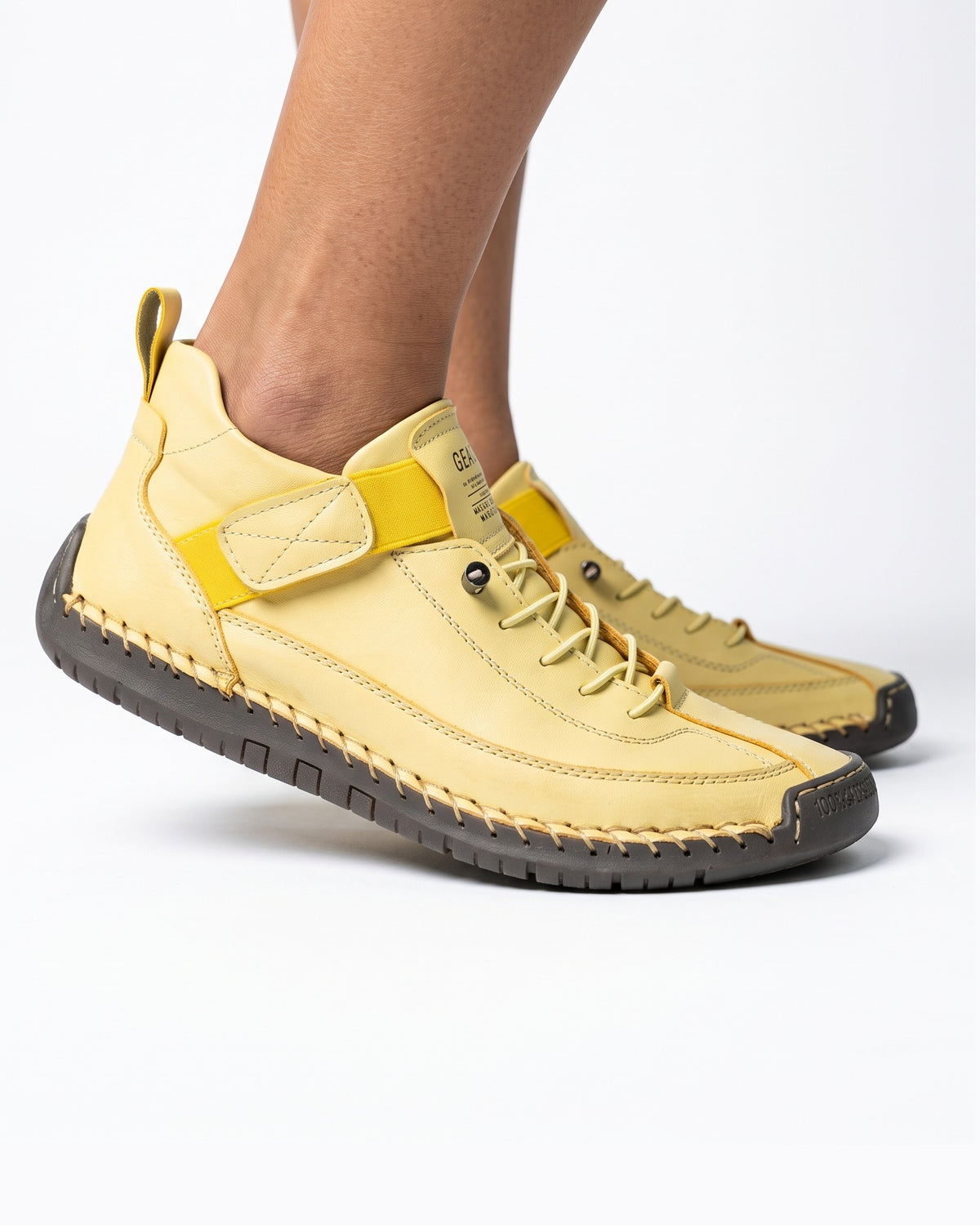 Yellow faux leather lace-up sneaker with ankle strap and textured rubber outsole