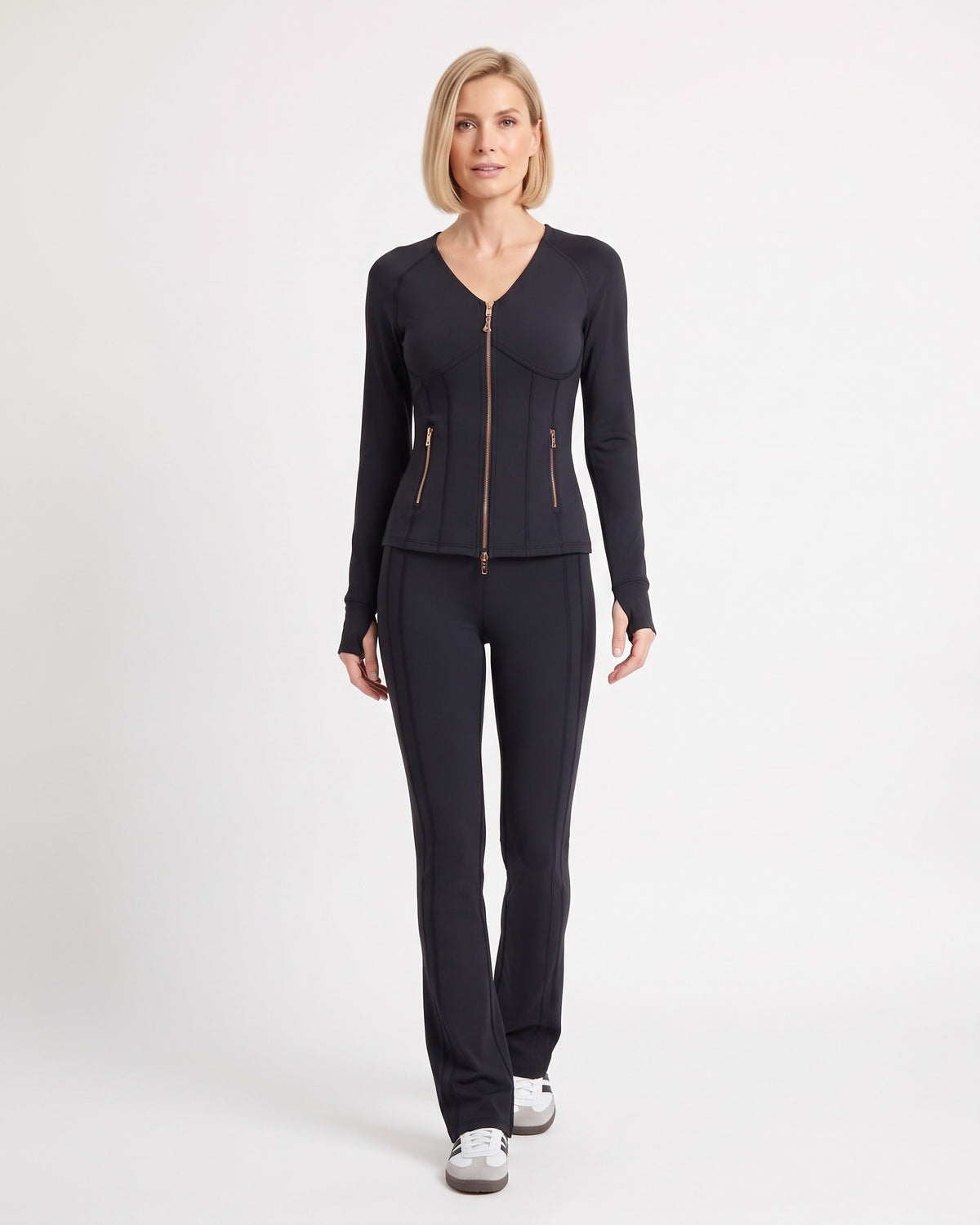 Black workout set with zip-front jacket and flared leggings, shown from the front