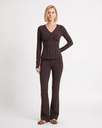Dark brown workout set with fitted zip jacket and flared leggings