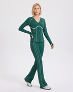 Dark green workout set with white piping, shown in a walking pose