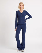 Navy workout set with fitted zip jacket and flared leggings