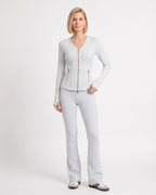 White workout set with fitted zip jacket and flared leggings