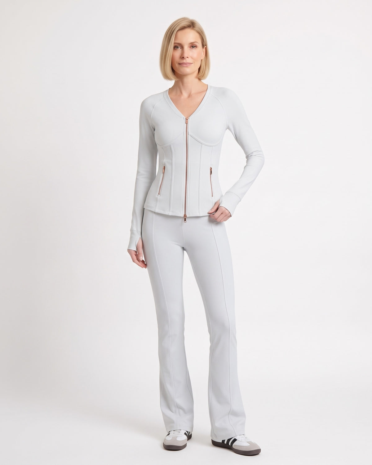 White workout set with fitted zip jacket and flared leggings