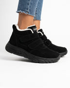 Black high-top sneakers with fleece lining and hook-and-loop straps, cushioned sole