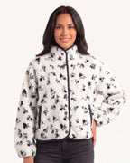 Women's cropped cream sherpa jacket with dark floral print, stand collar, snap buttons and piped trim