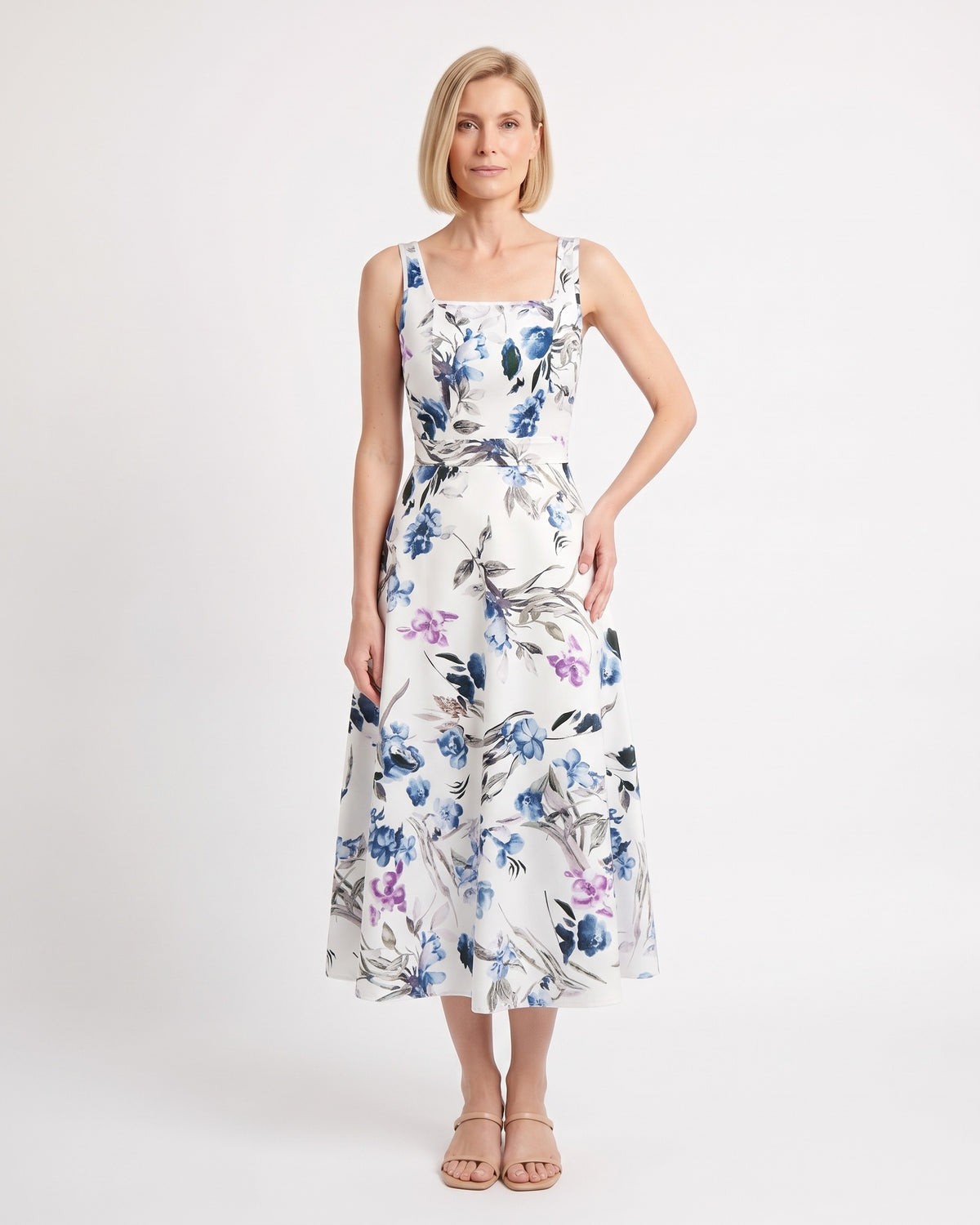 White floral midi dress with blue flowers, square neckline, wide straps and an A-line skirt