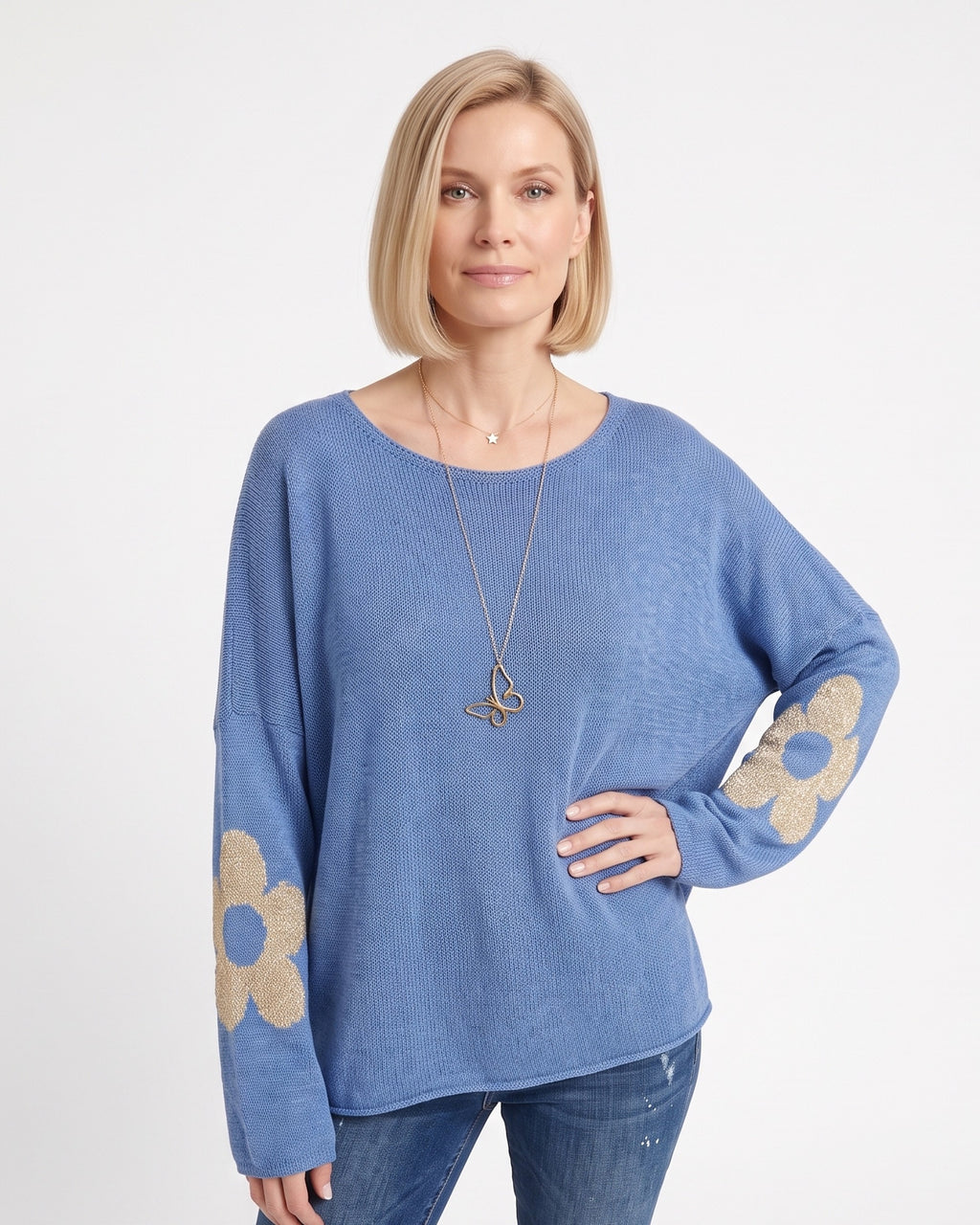 Blue women’s oversized knit pullover with metallic floral motifs on sleeves