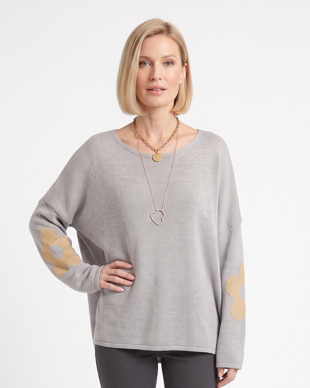 Oversized light gray knit sweater with drop shoulders and metallic flower motifs