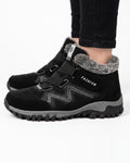 Women’s black fur-lined snow boots with hook-and-loop straps and rugged lug sole